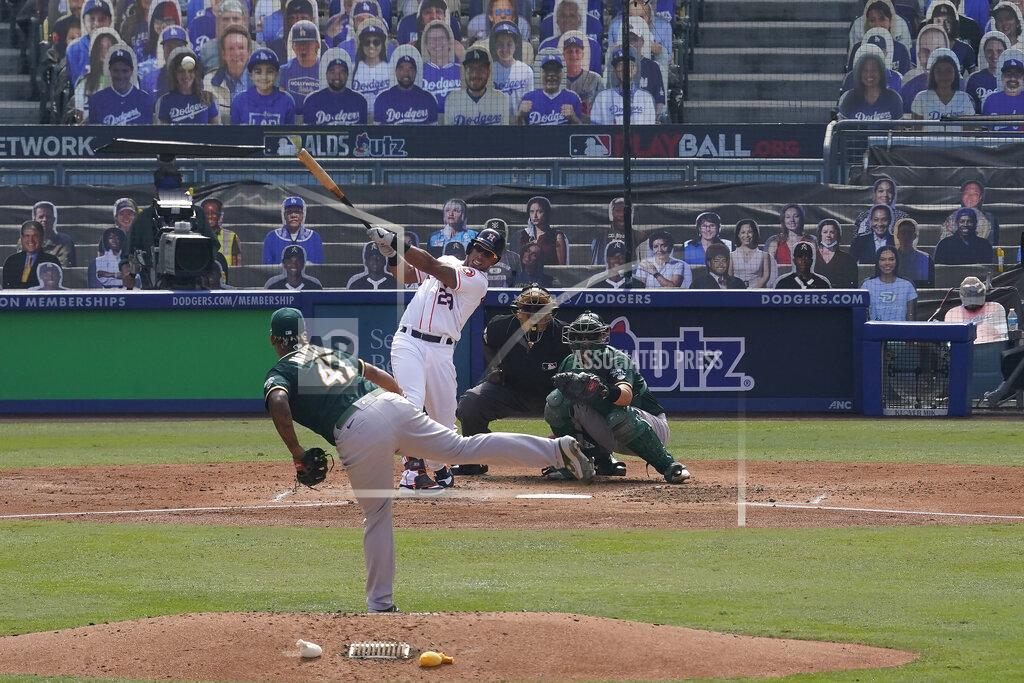 Marcio Jose Sanchez Houston Astros' Michael Brantley, center left, hits a two-run home run off of Oakland Athletics pitcher Frankie Montas, bottom, during the fourth inning of Game 4 of a baseball American League Division Series in Los Angeles, Thursday, Oct. 8, 2020. (AP Photo/Marcio Jose Sanchez)