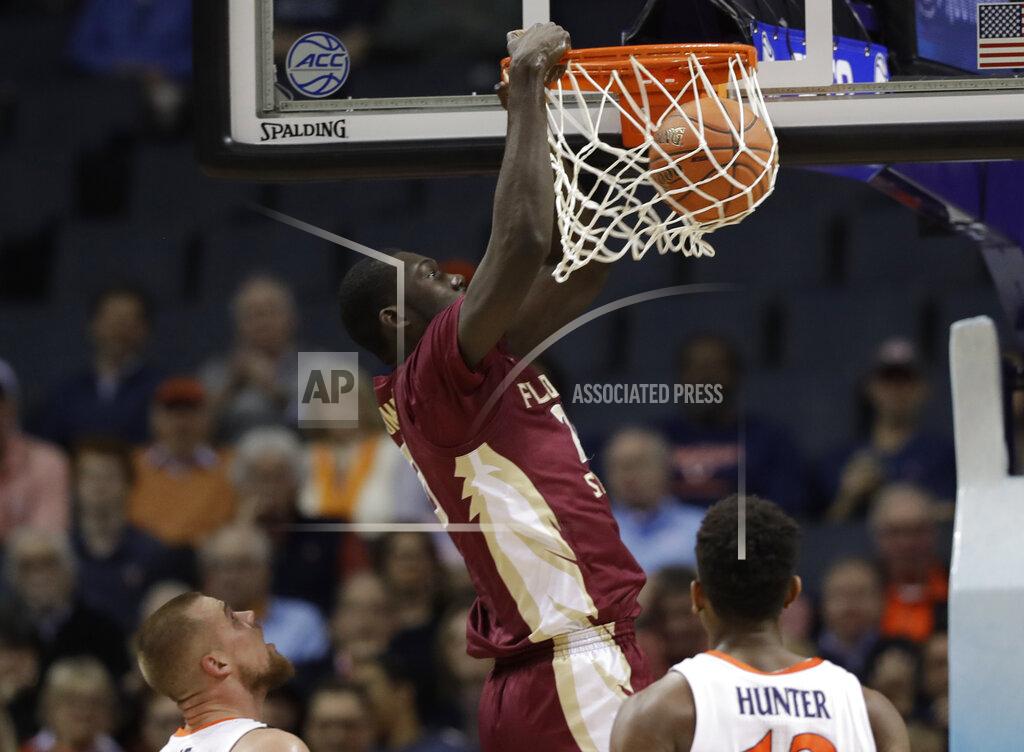 Chuck Burton Florida State's Christ Koumadje (21) dunks against Virginia during the first half of an NCAA college basketball game in the Atlantic Coast Conference tournament in Charlotte, N.C., Friday, March 15, 2019. (AP Photo/Chuck Burton)