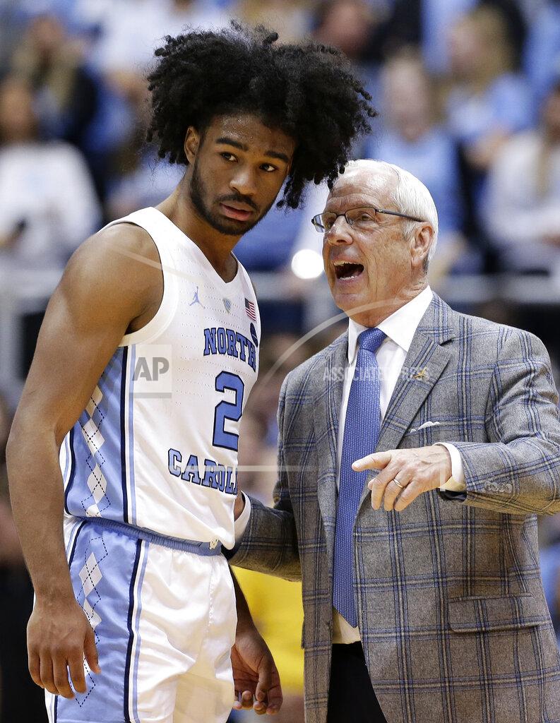 Gerry Broome North Carolina's Coby White (2) speaks with coach Roy Williams during overtime in an NCAA college basketball game against Miami in Chapel Hill, N.C., Saturday, Feb. 9, 2019. North Carolina won 88-85. (AP Photo/Gerry Broome)