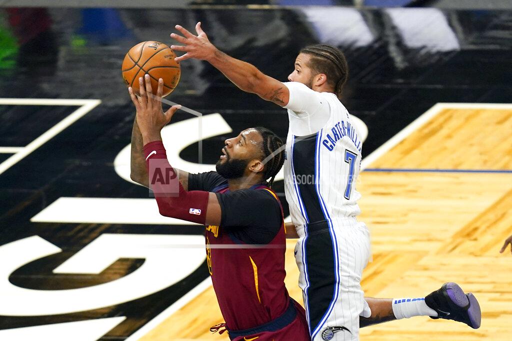 John Raoux Orlando Magic guard Michael Carter-Williams (7) blocks a shot by Cleveland Cavaliers center Andre Drummond, left, during the second half of an NBA basketball game, Monday, Jan. 4, 2021, in Orlando, Fla. (AP Photo/John Raoux)