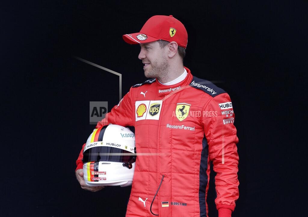 Ferrari driver Sebastian Vettel of Germany poses for a photo at the Australian Formula One Grand Prix in Melbourne, Thursday, March 12, 2020. (AP Photo/Rick Rycroft)