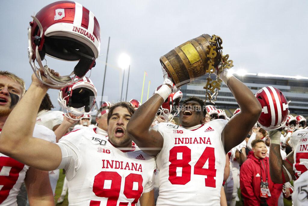 Michael Conroy FILE - In this Nov. 30, 2019, file photo, Indiana tight end Turon Ivy Jr. (84) and place kicker Nathanael Snyder (99) celebrate with the Old Oaken Bucket following an NCAA college football game against Purdue in West Lafayette, Ind. The Indiana-Purdue rivalry game has been canceled again. It will be the first time in-state rivals have not met in a football season since the Spanish flu pandemic forced cancellations in 1918 and ’19. (AP Photo/Michael Conroy, File)