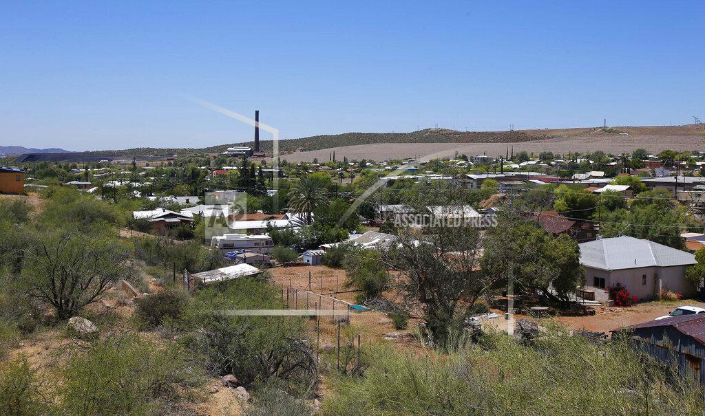 Ross D. Franklin FILE - This June 15, 2015 file photo, shows the town of Superior, Ariz., with its once-bustling mining operations and derelict smelter tower in the background. The U.S. Forest Service released an environmental review Friday, Jan. 15, 2021, that paves the way for the creation of one of the largest copper mines in the United States, against the wishes of a group of Apaches who have been trying for years to stop the project. The mountainous land near Superior is known as Oak Flat or Chi'chil Bildagoteel. It's where Apaches have harvested medicinal plants, held coming-of-age ceremonies, and gathered acorns for generations. (AP Photo/Ross D. Franklin, File)
