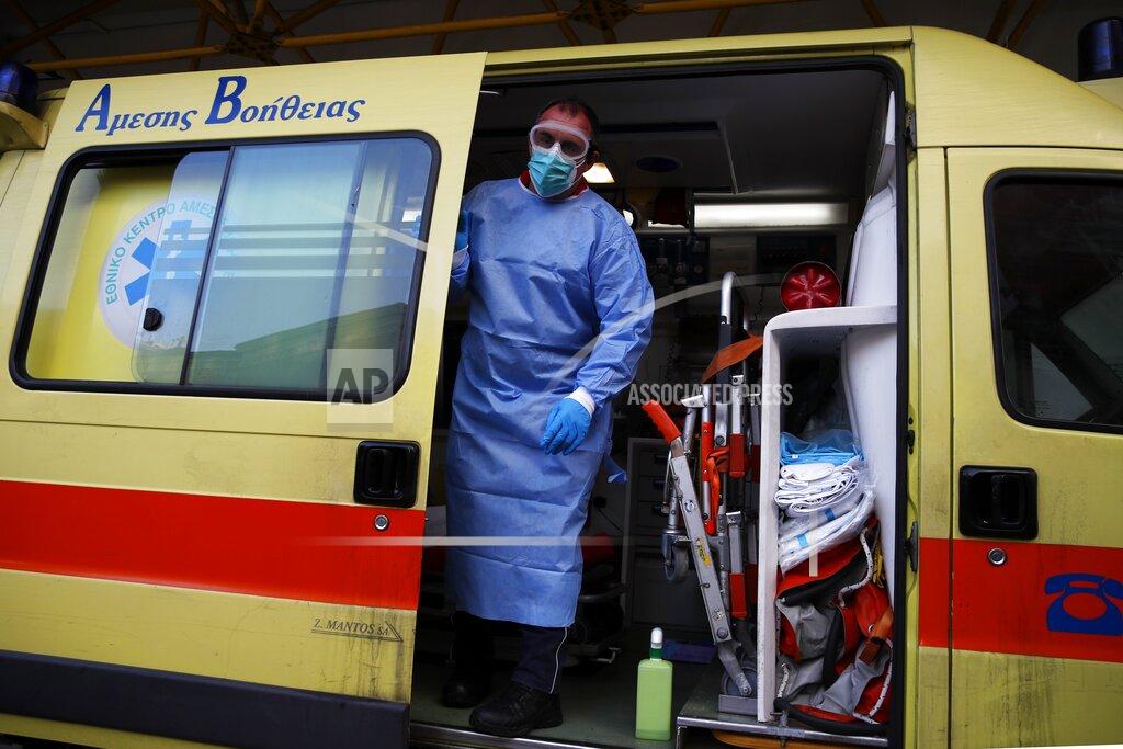 Thanassis Stavrakis A paramedic wearing a suit to protect against coronavirus, closes the door of an ambulance at Evangelismos hospital in Athens, Thursday, Nov. 12, 2020. Greece has imposed a nationwide nightly curfew as the number of COVID-19 cases in the country continues to surge despite a lockdown. (AP Photo/Thanassis Stavrakis)