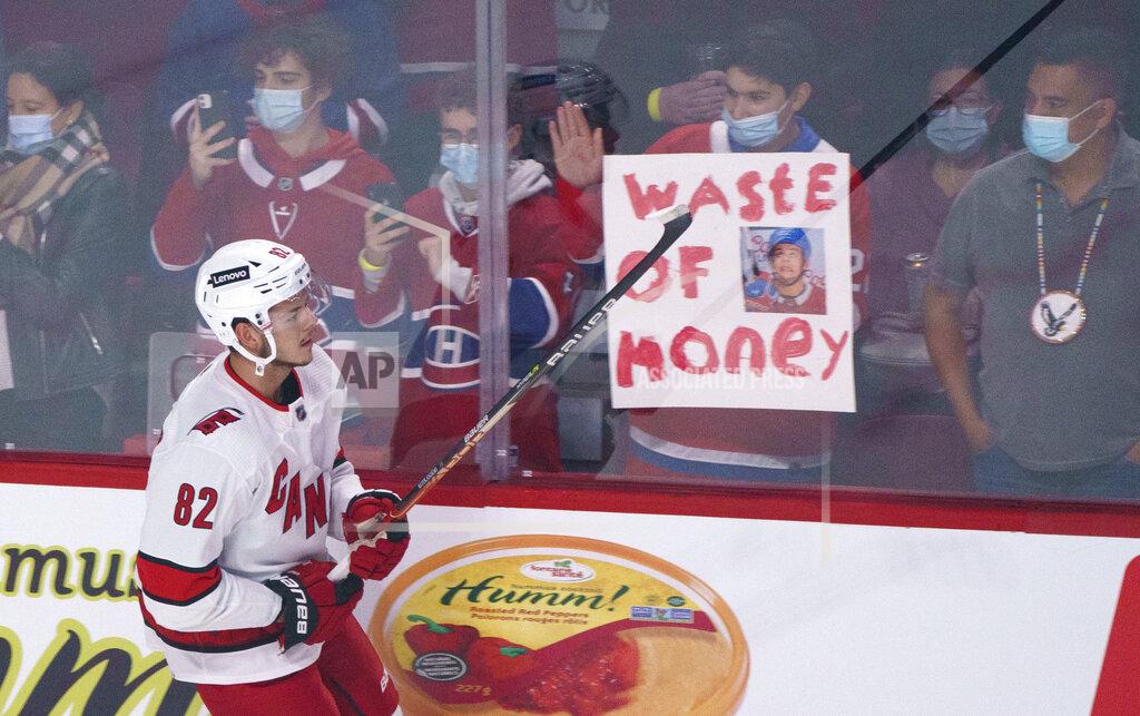 Paul Chiasson Carolina Hurricanes' Jesperi Kotkaniemi skates by a sign as he warms up before the Hurricanes' NHL hockey game against his former team, the Montreal Canadiens, in Montreal on Thursday, Oct. 21, 2021. (Paul Chiasson/The Canadian Press via AP)