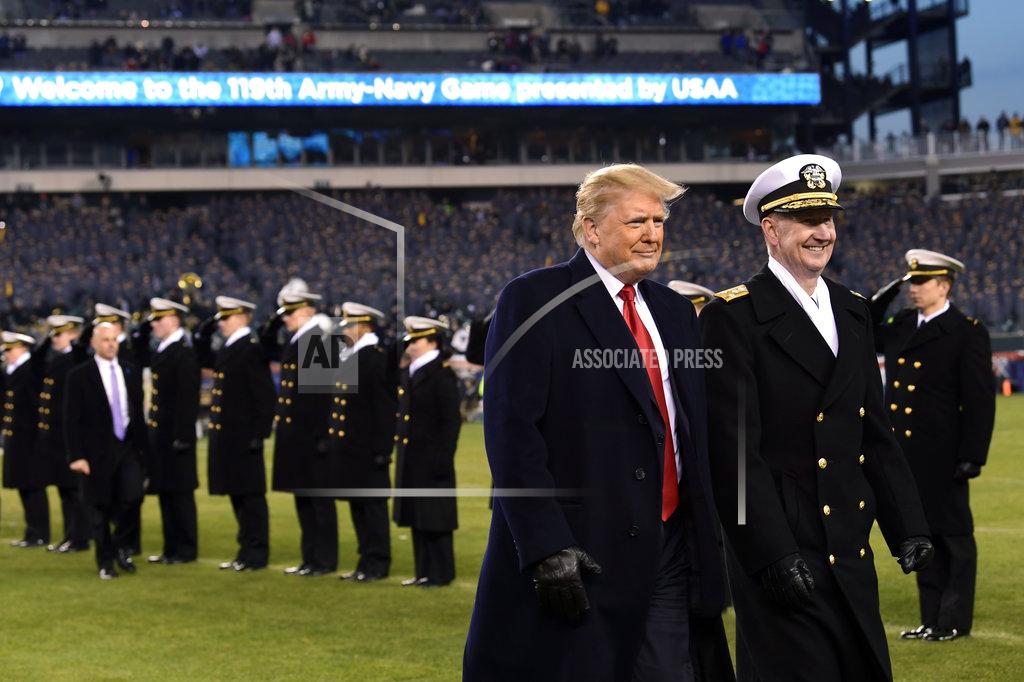 Susan Walsh President Donald Trump, center, walks with Naval Academy Superintendent Vice Adm. Ted Carter, right, across the field during half-time at the Army-Navy football game in Philadelphia, Saturday, Dec. 8, 2018. (AP Photo/Susan Walsh)