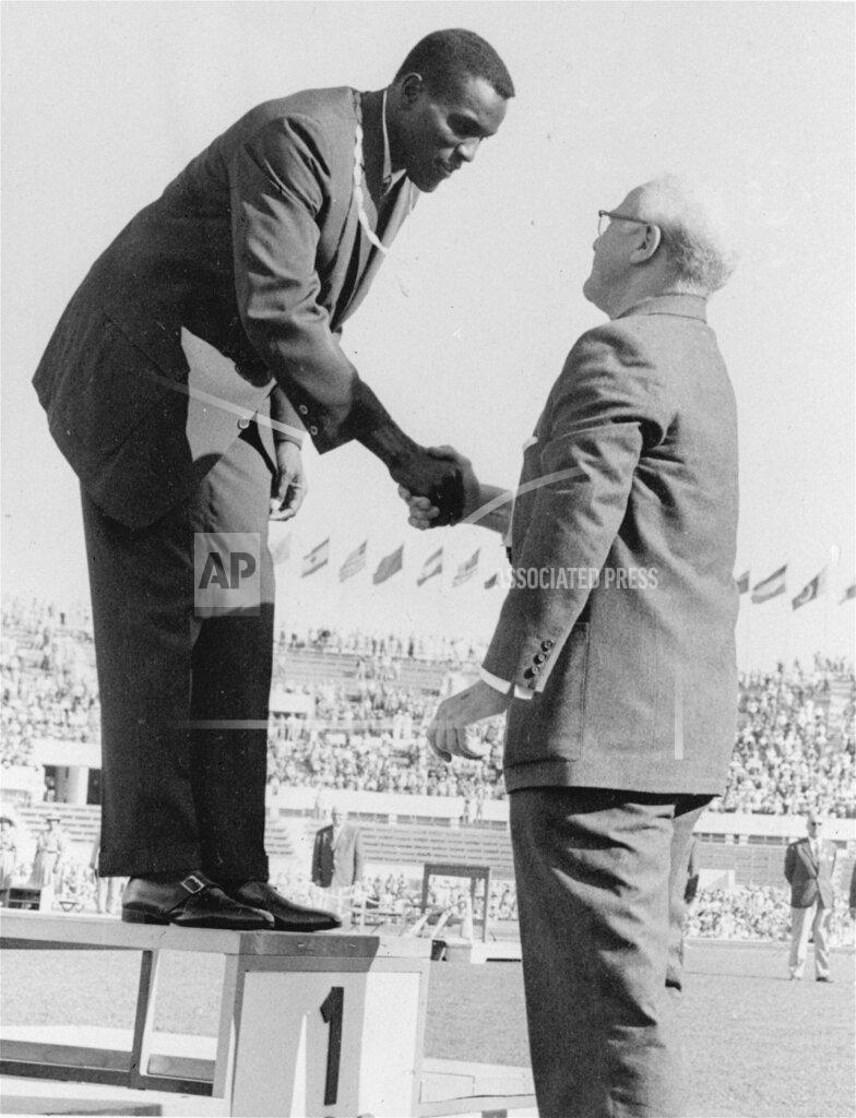 Uncredited FILE - Rafer Johnson of Kingsburg, Calif., is congratulated by International Olympic Committee President Avery Brundage after presentation of the gold medal for the decathlon event at the Summer Olympics in Rome, Italy, in this Sept., 7, 1960, file photo. Rafer Johnson died Wednesday, Dec. 2, 2020. He was 86. He died at his home in the Sherman Oaks section of Los Angeles, according to family friend Michael Roth (AP Photo)