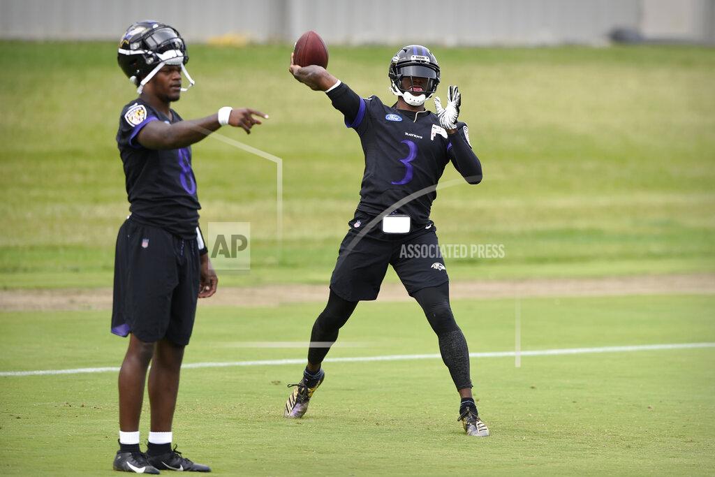 Gail Burton Baltimore Ravens quarterback Robert Griffin III, right, passes as Lamar Jackson points during drills at the team's NFL football training facility in Owings Mills, Md., Wednesday, June 12, 2019 (AP Photo/Gail Burton)