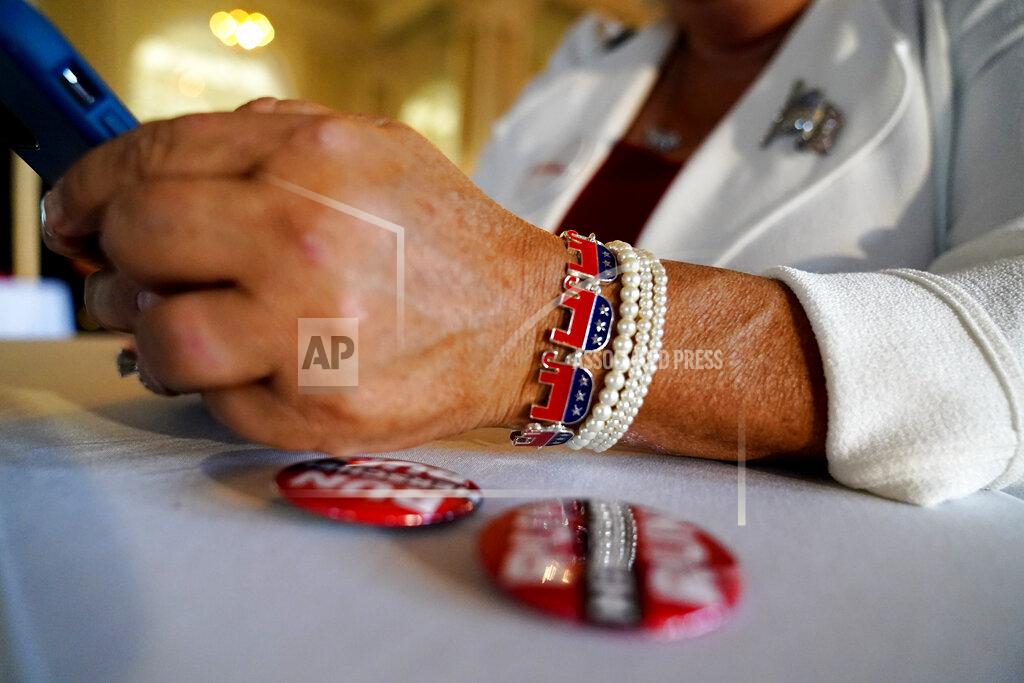 Brynn Anderson Cobb County, Ga., GOP chairperson Salleigh Grubbs looks at her phone during an election night watch party for U.S. Senate candidate Herschel Walker, Tuesday, May 24, 2022, in Atlanta. (AP Photo/Brynn Anderson)