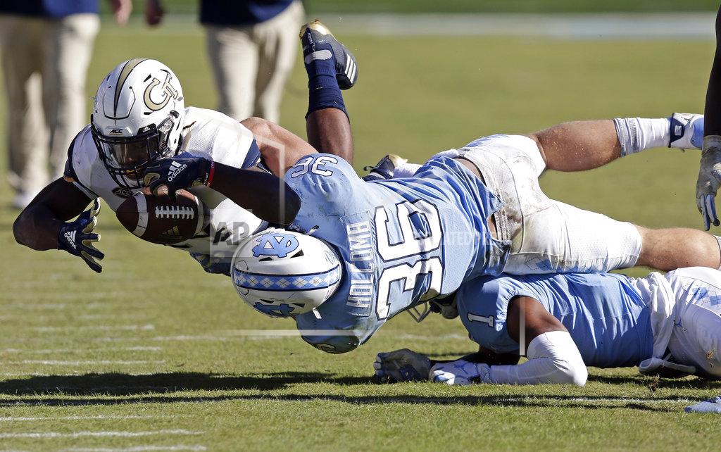 Gerry Broome North Carolina's Cole Holcomb (36) tackles Georgia Tech's Jordan Mason (24) during the second half of an NCAA college football game in Chapel Hill, N.C., Saturday, Nov. 3, 2018. Georgia Tech won 38-28. (AP Photo/Gerry Broome)