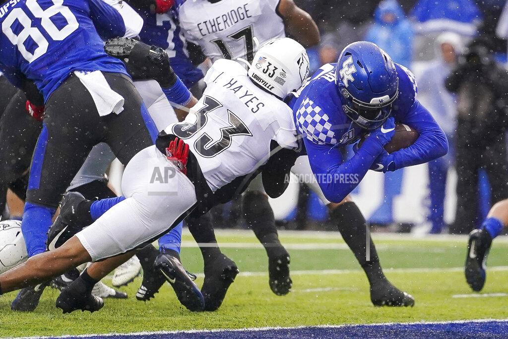 Bryan Woolston Kentucky running back Asim Rose scores a touchdown as he is tackled by Louisville defensive back Isaiah Hayes (33) during the first half of the NCAA college football game, Saturday, Nov. 30, 2019, in Lexington, Ky. (AP Photo/Bryan Woolston)