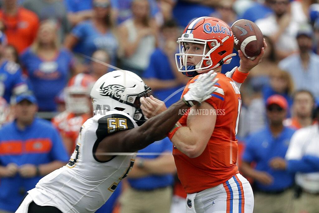 John Raoux Florida quarterback Kyle Trask, right, throws a pass as he is hit by Towson linebacker Christian Dixon (55) during the first half of an NCAA college football game, Saturday, Sept. 28, 2019, in Gainesville, Fla. (AP Photo/John Raoux)