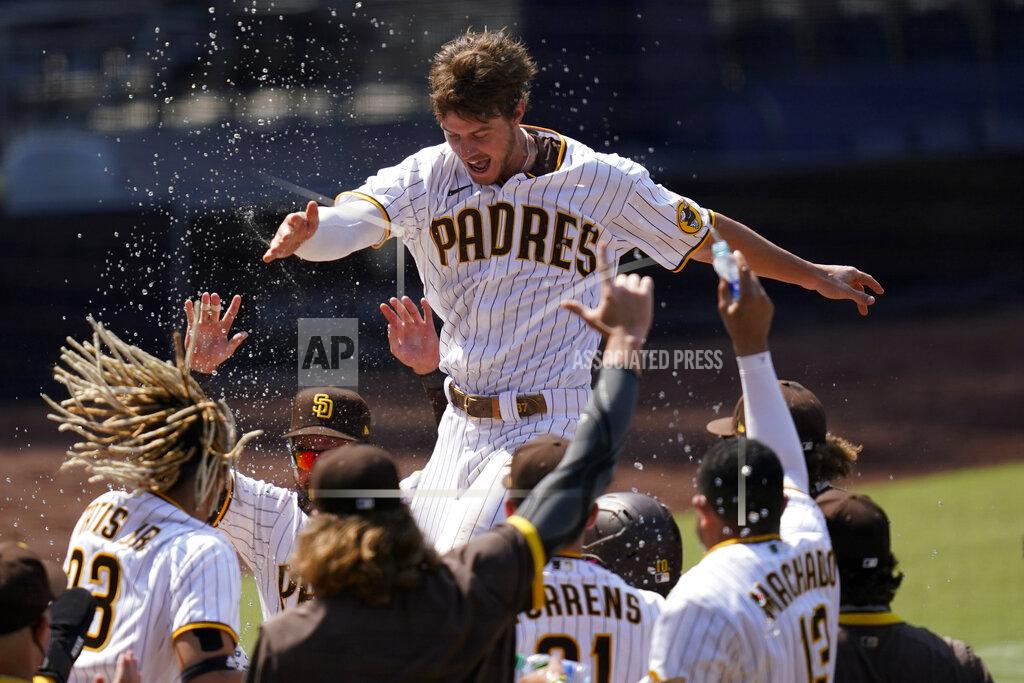Gregory Bull FILE - In this Aug. 27, 2020 file photo, San Diego Padres' Wil Myers, top, reacts after hitting a three-run walkoff home run to defeat the Seattle Mariners in a baseball game in San Diego. Wil Myers is back. While Manny Machado and Fernando Tatis Jr. have grabbed most of the attention on the playoff-bound Padres, Myers' comeback performance has also been instrumental in returning San Diego to postseason play for the first time since 2006. Myers is hitting .291 with 14 homers and 38 RBIs in 52 games. (AP Photo/Gregory Bull, File)