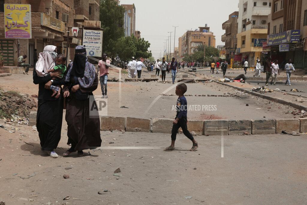 Marwan Ali People cross barriers blocking streets during a protest demanding a return to civilian rule and to protest the nine people who were killed in anti-military demonstrations last month, in Khartoum, Sudan, Monday, July 4, 2022. (AP Photo/Marwan Ali)