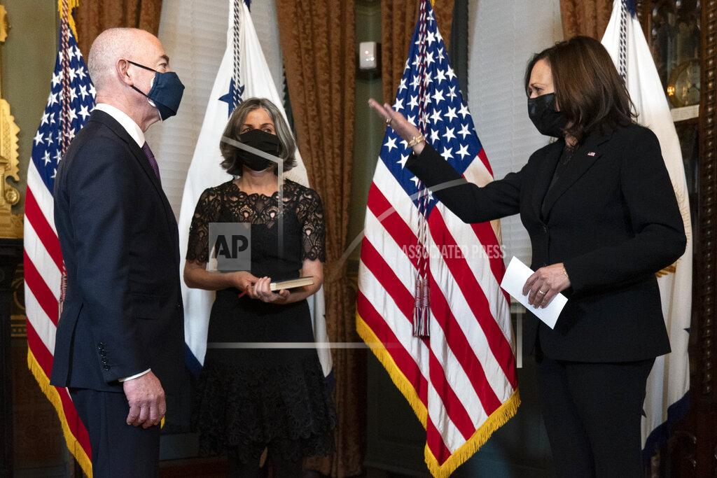 Jacquelyn Martin Vice President Kamala Harris, right, congratulates Alejandro Mayorkas, left, before ceremonially swearing him in as Secretary of the Department of Homeland Security, accompanied by his wife Tanya Mayorkas, Tuesday, Feb. 2, 2021, at the Eisenhower Executive Office Building on the White House Complex in Washington. (AP Photo/Jacquelyn Martin)
