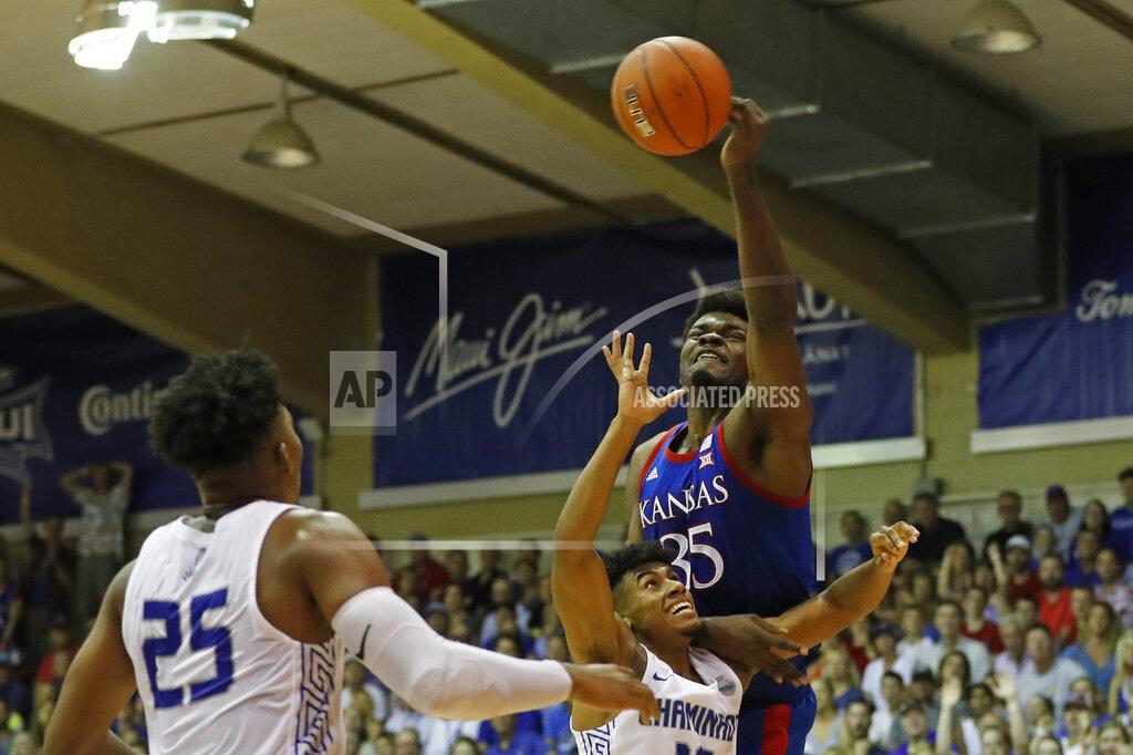 Marco Garcia Kansas center Udoka Azubuike (35) slaps the ball away from Chaminade guard Andre Arissol (10) during an NCAA college basketball game Monday, Nov. 25, 2019, in Lahaina, Hawaii. (AP Photo/Marco Garcia)