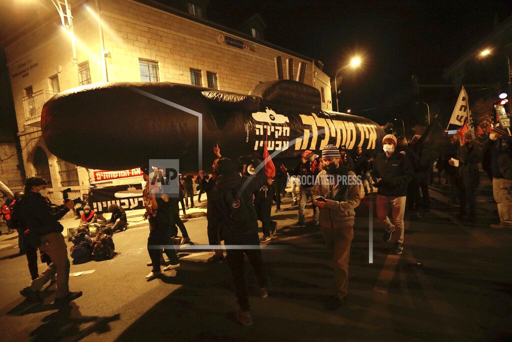 Sebastian Scheiner Israeli protesters chant slogans during a demonstration against Israeli Prime Minister Benjamin Netanyahu In Jerusalem, Saturday, Jan. 23, 2021. (AP Photo/Sebastian Scheiner)