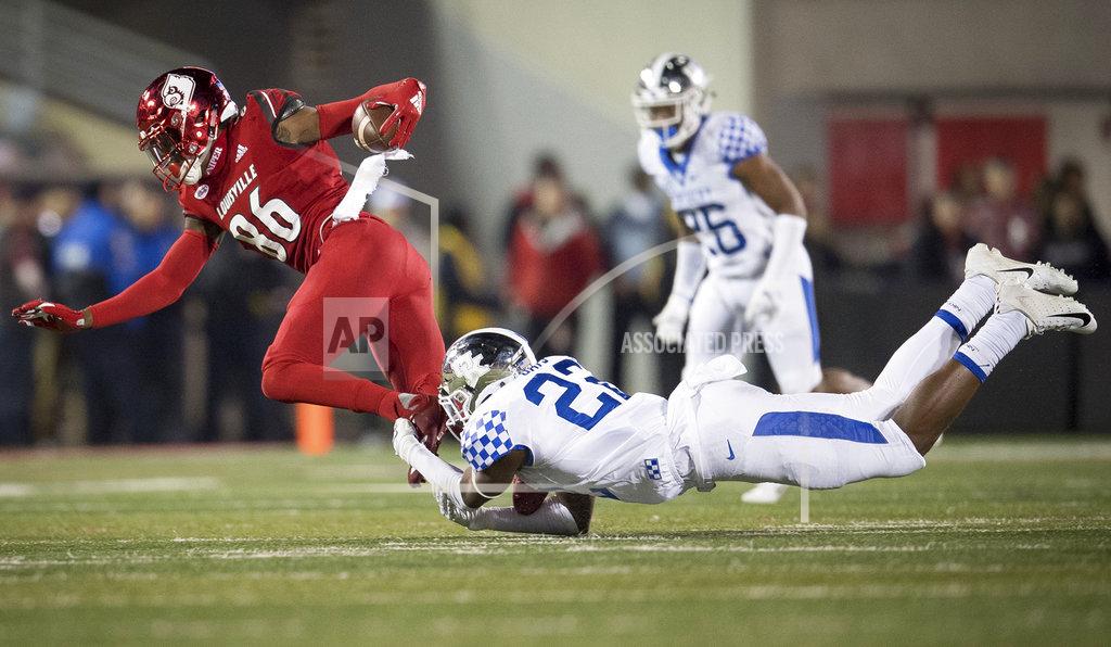 Bryan Woolston Louisville wide receiver Devante Peete (86) is tackled by Kentucky safety Tyrell Ajian (23) during the second half of the NCAA college football game in Louisville, Ky., Saturday, Nov. 24, 2018. (AP Photo/Bryan Woolston)