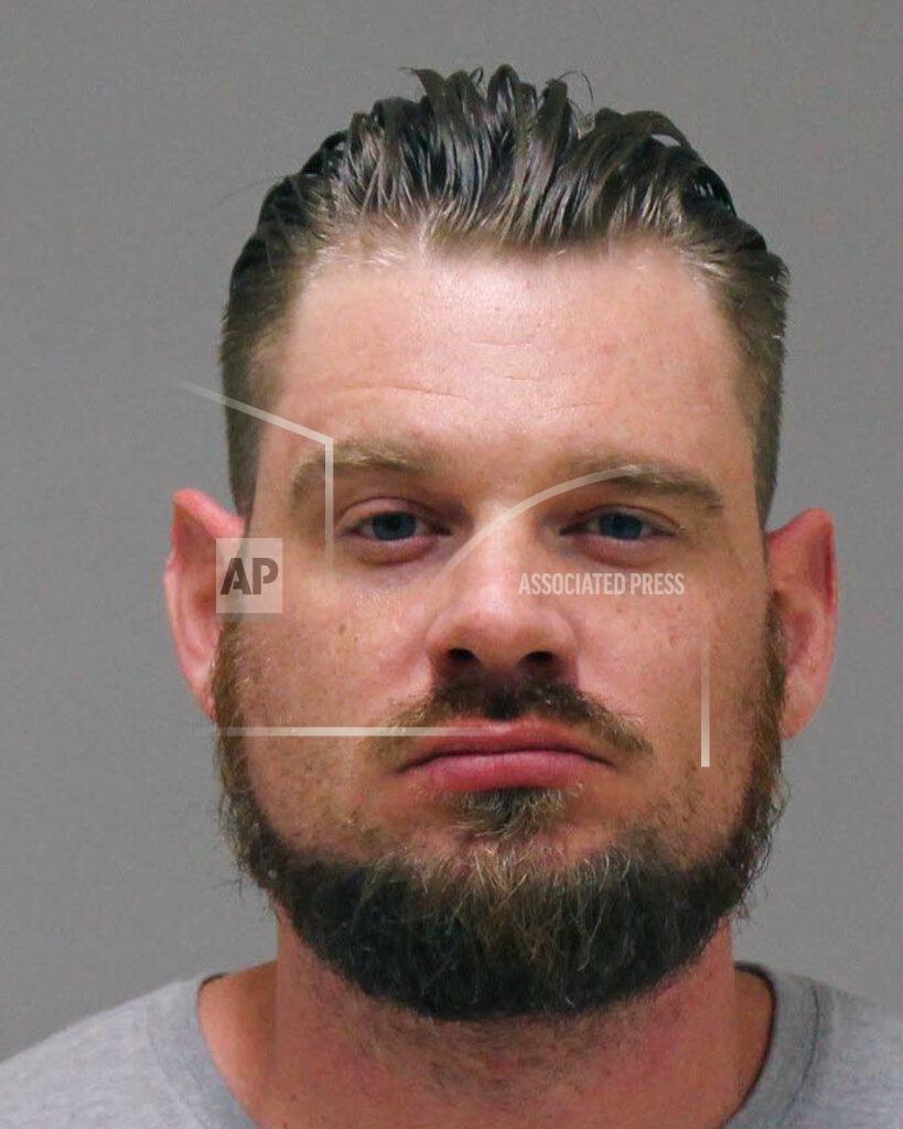 Uncredited In a photo provided by the Kent County Sheriff, Adam Dean Fox is shown in a booking photo. Fox is one of several people charged with plotting to kidnap Michigan Democratic Gov. Gretchen Whitmer, authorities said Thursday, Oct. 8, 2020, in announcing charges in an alleged scheme that involved months of planning and even rehearsals to snatch Whitmer from her vacation home. (Kent County Sheriff via AP)