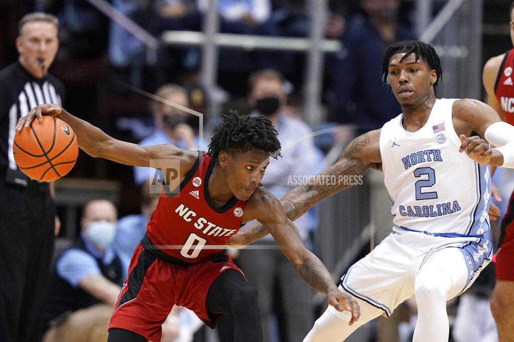 Gerry Broome North Carolina State guard Terquavion Smith (0) dribbles while North Carolina guard Caleb Love (2) defends during the first half of an NCAA college basketball game in Chapel Hill, N.C., Saturday, Jan. 29, 2022. (AP Photo/Gerry Broome)