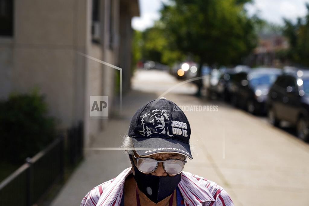David Goldman Ethel Watts, 80, makes the half-mile walk home with fresh groceries from a food distribution site at St. Sabina Catholic Church in the Auburn Gresham neighborhood in Chicago, Thursday, Aug. 27, 2020. Auburn Gresham has faced hard times before. Guns are easy to find. Fresh produce isn't. Poverty hovers around 20 percent. But there's never been anything like this: A once-in-a-century epidemic in a community without a hospital. (AP Photo/David Goldman)