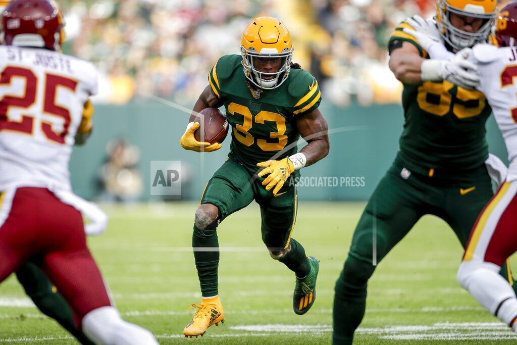 Aaron Gash Green Bay Packers' Aaron Jones runs during the first half of an NFL football game against the Washington Football Team Sunday, Oct. 24, 2021, in Green Bay, Wis. (AP Photo/Aaron Gash)
