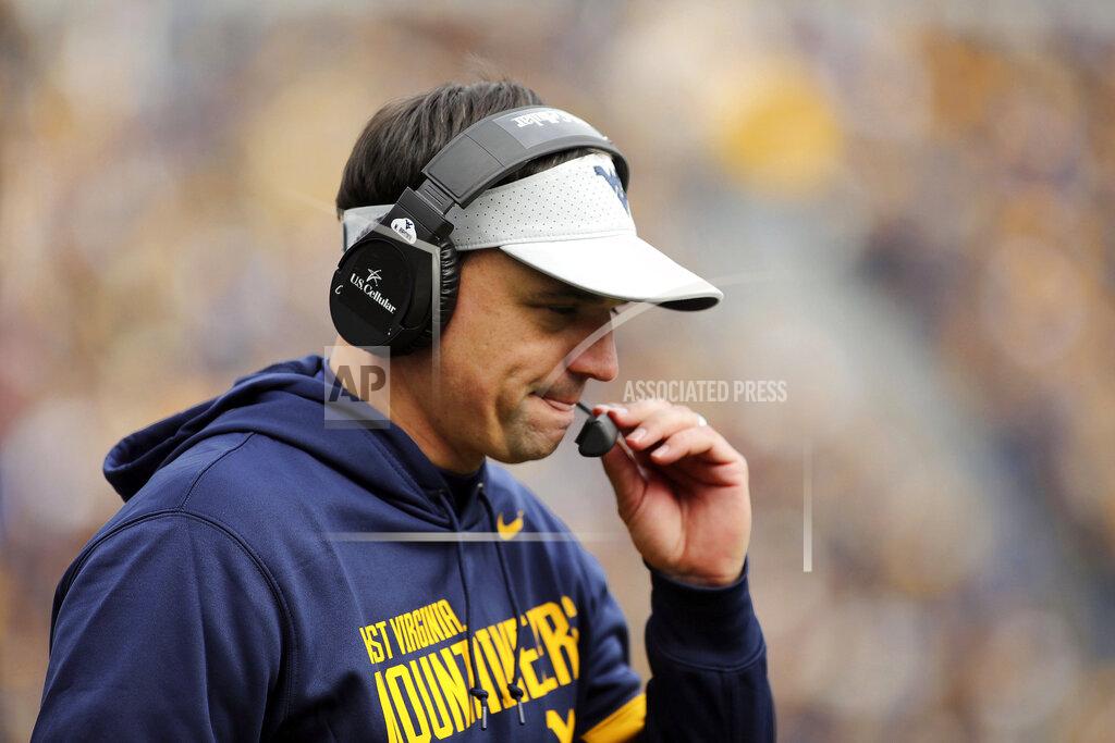 Chris Jackson West Virginia head coach Neal Brown holds his mic during their NCAA college football game against Texas Tech in Morgantown, W.Va., Saturday, Nov. 9, 2019. (AP Photo/Chris Jackson)