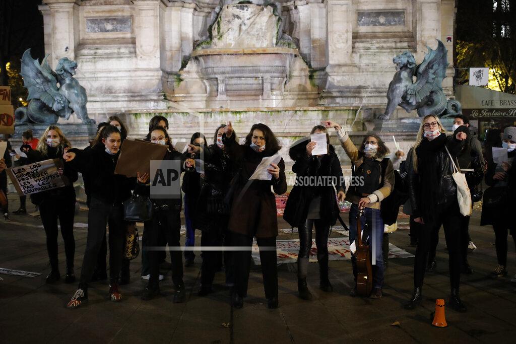 Francois Mori Women gather at the Saint Michel fountain Wednesday, Nov. 25, 2020 in Paris. With domestic violence on the rise amid the pandemic, activists are holding protests Wednesday from France to Turkey and world dignitaries are trying to find ways to protect millions of women killed or abused every year by their partners. (AP Photo/Francois Mori)