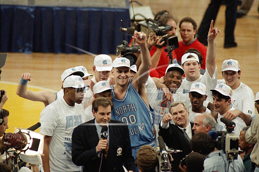 Bob Jordan FILE - In this April 5, 1993, file photo, North Carolina coach Dean Smith at front center right, points as he celebrates a 77-71 win against Michigan in the NCAA Final Four championship basketball game in New Orleans. At center is Eric Montross (00). The game wasn’t settled until Michigan’s Chris Webber called a timeout the Wolverines didn’t have with 11 seconds to go. ″You can call it lucky, you can call it fortunate, but it still says NCAA championship,″ Smith said. (AP Photo/Bob Jordan, File)