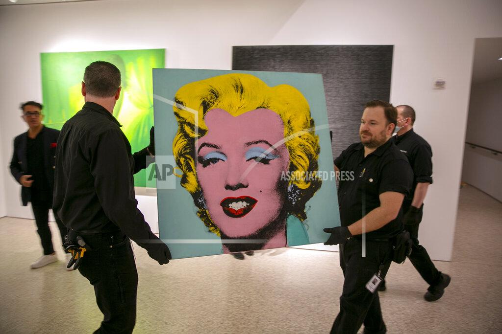 Ted Shaffrey The 1964 painting "Shot Sage Blue Marilyn," by Andy Warhol is carried in Christie's showroom in New York City, on Sunday, May 8, 2022. The silkscreen sold for a cool $195 million on Monday, making the iconic portrait of Marilyn Monroe the most expensive work by a U.S. artist ever sold at auction. (AP Photo/Ted Shaffrey)