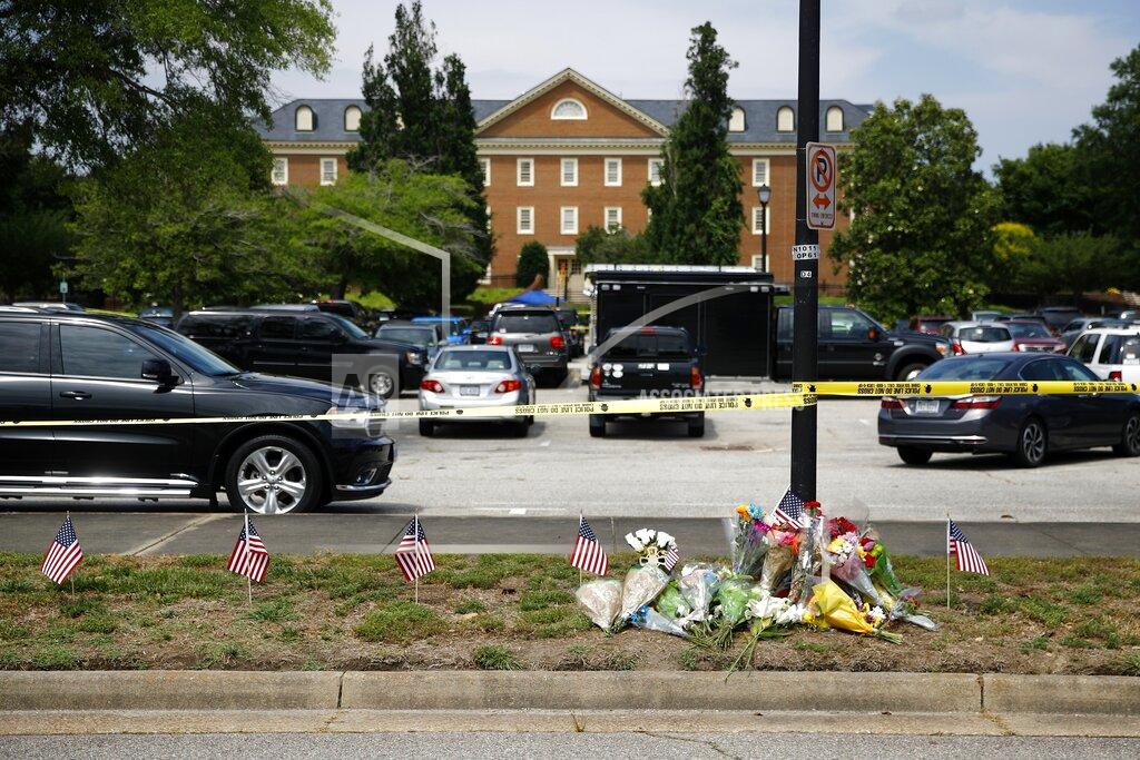 Patrick Semansky FILE - In this June 1, 2019, file photo, a makeshift memorial rests at the edge of a police cordon in front of a municipal building that was the scene of a shooting in Virginia Beach, Va. As the shooting's one-year anniversary approaches, some of the victim's family members say the rampage is effectively forgotten. (AP Photo/Patrick Semansky, File)