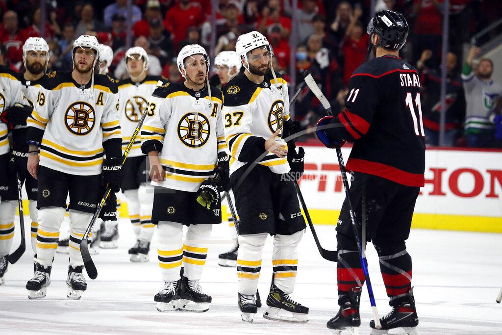 Karl B Deblaker Boston Bruins' Patrice Bergeron (37) and Brad Marchand (63) wait in line to shake hands with Carolina Hurricanes' Jordan Staal (11) and the rest of the Hurricanes following the Hurricanes' win in Game 7 of an NHL hockey Stanley Cup first-round playoff series in Raleigh, N.C., Saturday, May 14, 2022. (AP Photo/Karl B DeBlaker)