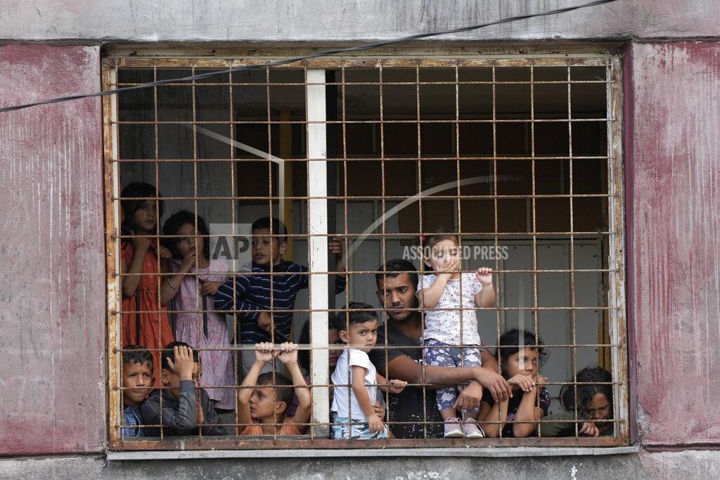 Gregorio Borgia Residents watch Pope Francis meeting with members of the Roma community at Lunik IX, in Kosice, Slovakia, Tuesday, Sept. 14, 2021, the biggest of about 600 segregated settlements where the poorest 20% of Slovakia's 400,000 Roma live. Pope Francis traveled to Kosice, in the far east of Slovakia on Tuesday to meet with the country's Roma in a gesture of inclusion for the most socially excluded minority group in Slovakia, who have long suffered discrimination, marginalization and poverty. (AP Photo/Gregorio Borgia)