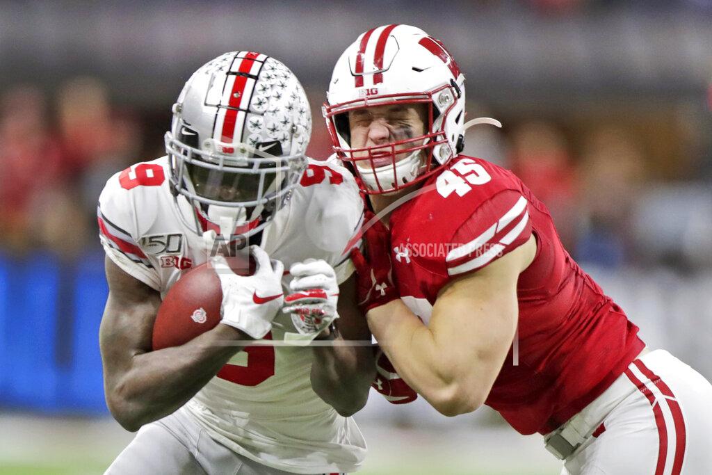 Michael Conroy Ohio State wide receiver Binjimen Victor (9) is tackled by Wisconsin linebacker Leo Chenal (45) during the second half of the Big Ten championship NCAA college football game Saturday, Dec. 7, 2019, in Indianapolis. (AP Photo/Michael Conroy)