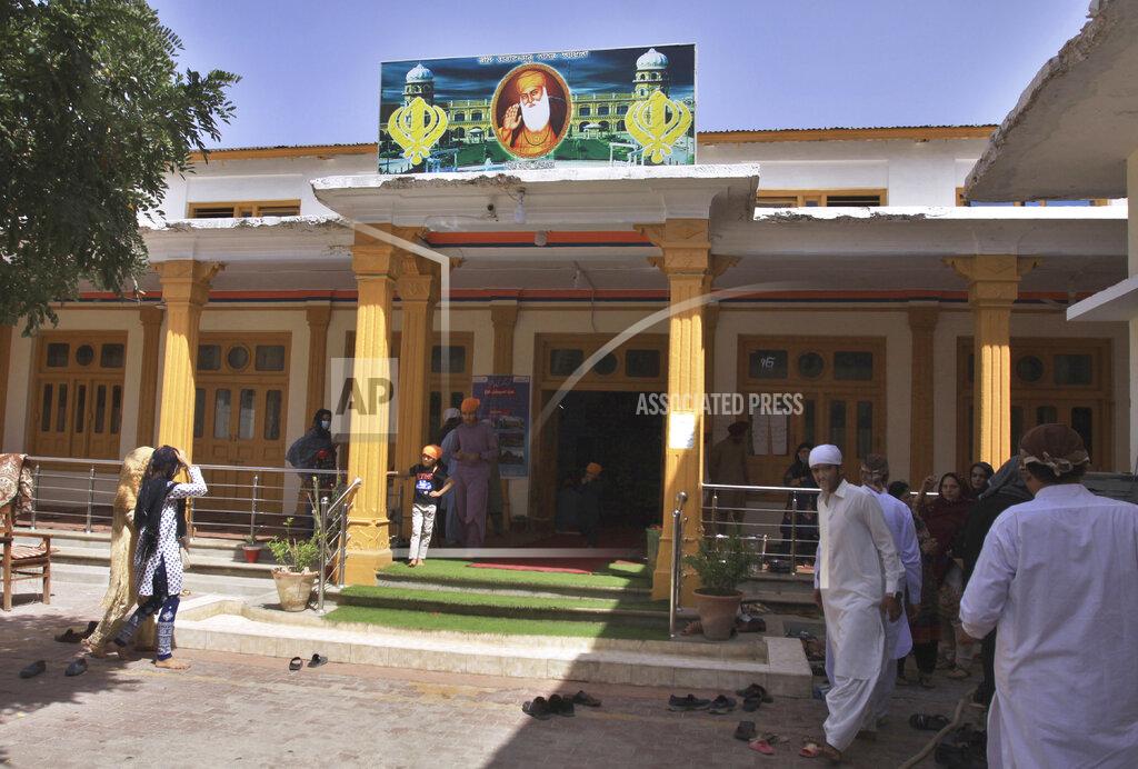 Members of the Sikh community arrive for worship at the Gurudawara Sri Guru Singh Sabha temple in Quetta, Pakistan, Thursday, July 23, 2020. The 200-year-old Sikh temple that served as a school for Muslim girls for seven decades was returned to the Sikh community in the city of Quetta, enabling them to worship there for the first time in 73 years, officials said Thursday. (AP Photo/Arshad Butt)