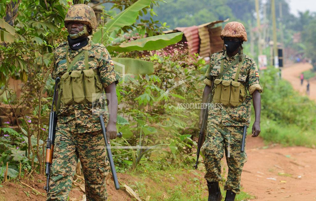 Nicholas Bamulanzeki Soldiers patrol outside opposition challenger Bobi Wine's home in Magere, Kampala, Uganda, Saturday, Jan. 16, 2021, after President Yoweri Museveni was declared the winner of the presidential election. Uganda’s electoral commission says longtime President Yoweri Museveni has won a sixth term, while top opposition challenger Bobi Wine alleges rigging and officials struggle to explain how polling results were compiled amid an internet blackout. In a generational clash widely watched across the African continent, the young singer-turned-lawmaker Wine posed arguably the greatest challenge yet to Museveni. (AP Photo/Nicholas Bamulanzeki)
