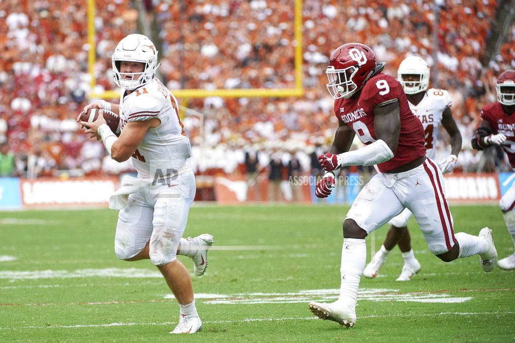Cooper Neill Texas quarterback Sam Ehlinger (11) runs after making a catch against Oklahoma during the first half of an NCAA college football game at the Cotton Bowl, Saturday, Oct. 6, 2018, in Dallas. (AP Photo/Cooper Neill)