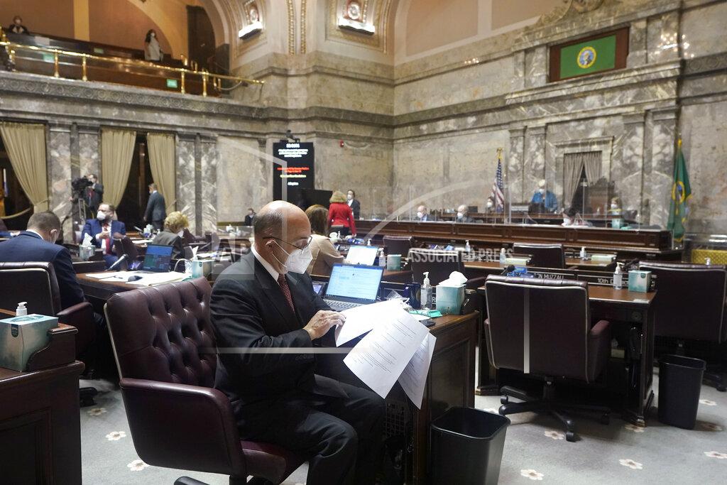Ted S. Warren FILE - In this Jan. 11, 2021 file photo, Sen. Keith Wagoner, R-Sedro-Woolley, sits at his desk on the Senate floor on the first day of the 2021 legislative session at the Capitol in Olympia, Wash. The 2021 session of the Washington Legislature ended Sunday, April 25 and lawmakers had no shortage of weighty topics to consider while having to conduct their work amid a pandemic that meant most meetings and votes were conducted remotely. The Capitol building was also closed to the public since last year due to the COVID-19 pandemic, and was surrounded by security fencing and national guard members at times due to fears of protests. (AP Photo/Ted S. Warren, File)