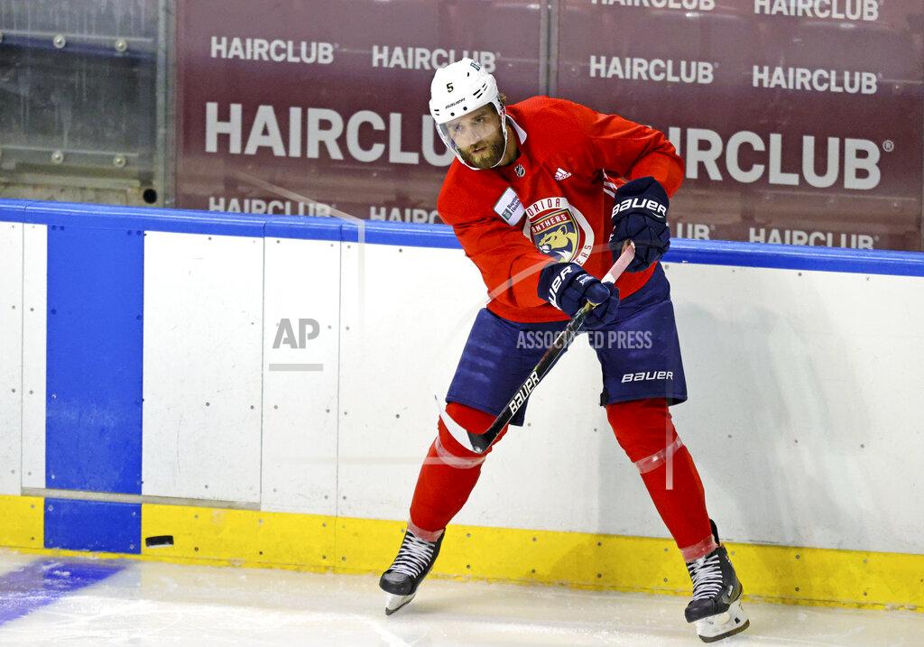 David Santiago Florida Panthers defenseman Aaron Ekblad passes the puck during an NHL hockey training camp Thursday, Sept. 23, 2021, in Sunrise, Fla. (David Santiago/Miami Herald via AP)