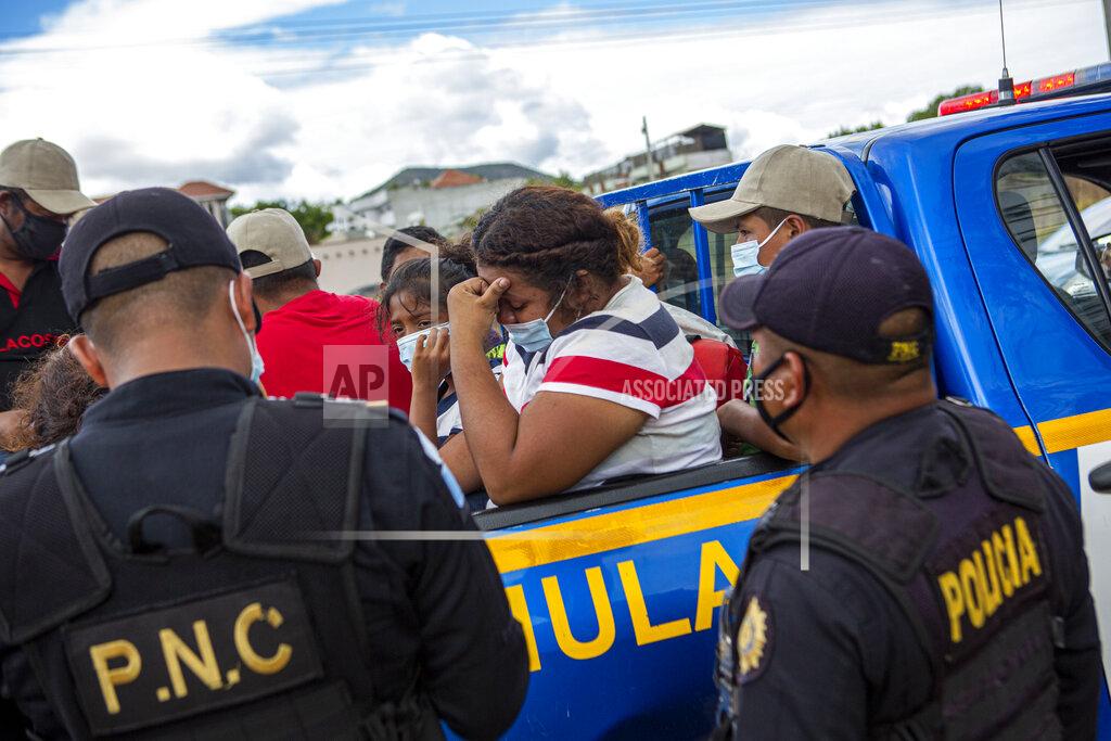 Oliver De Ros A Honduran migrant woman trying to reach the U.S. cries after she was detained in the Guatemalan department of Chiquimula, Tuesday, Jan. 19, 2021. A once large caravan of Honduran migrants that pushed its way into Guatemala last week had dissipated by Tuesday in the face of Guatemalan security forces. (AP Photo/Oliver de Ros)