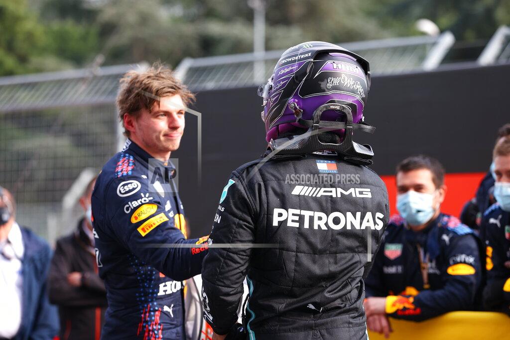Bryn Lennon CORRECTS PILOT'S NAME ON THE LEFT - First placed Red Bull's Max Verstappen, left, greets second placed Mercedes Lewis Hamilton at the end of the Emilia Romagna Formula One Grand Prix, at the Imola racetrack, Italy, Sunday, April 18, 2021. (Bryn Lennon/ Pool Via AP)