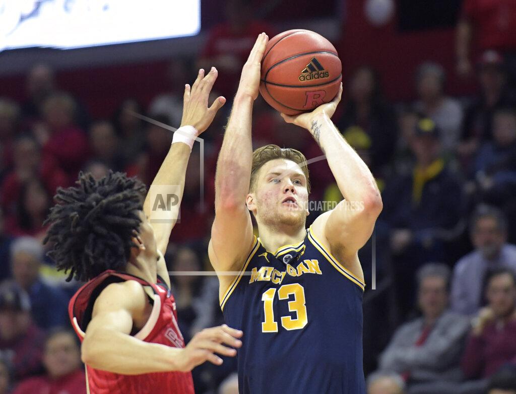 Bill Kostroun Michigan forward Ignas Brazdeikis (13) shoots as Rutgers guard Geo Baker defends during the second half of an NCAA college basketball game Tuesday, Feb. 5, 2019, in Piscataway, N.J. Michigan won 77-65. (AP Photo/Bill Kostroun)