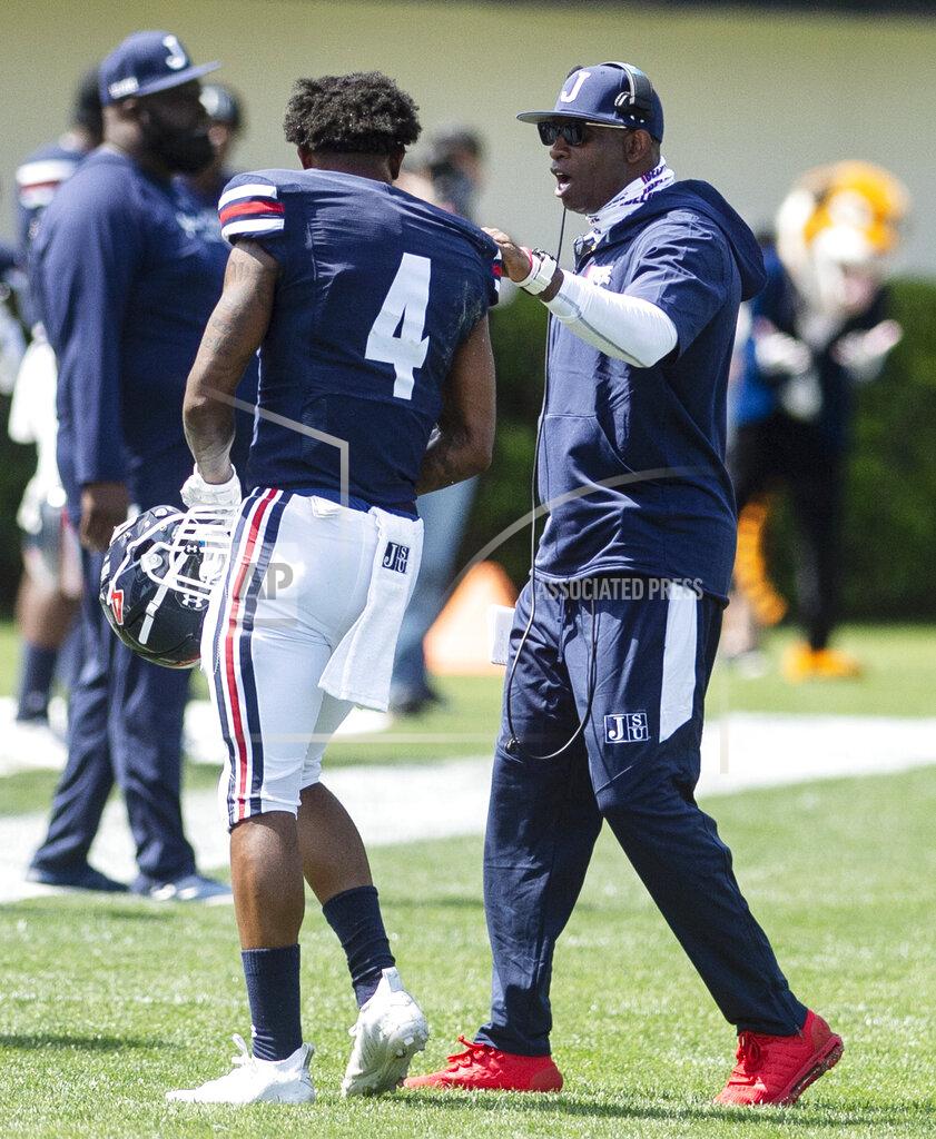 Eric Shelton Jackson State head football coach Deion Sanders, right, talks to De'Jahn Warren during an NCAA college football game against Alabama A&M, Saturday, April 10, 2021, at Veterans Memorial Stadium in Jackson, Miss. (Eric Shelton/The Clarion-Ledger via AP)