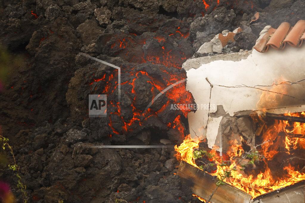 Kike Rincon FILE - In this Monday Sept. 20, 2021 file photo, lava from a volcano engulfs a building near El Paso on the island of La Palma in the Canaries, Spain. A long-dormant volcano on a small Spanish island in the Atlantic Ocean erupted on Sunday Sept. 19, 2021, forcing the evacuation of thousands of people. Huge plumes of black-and-white smoke shot out from a volcanic ridge where scientists had been monitoring the accumulation of molten lava below the surface. (Kike Rincon, Europa Press via AP, File)