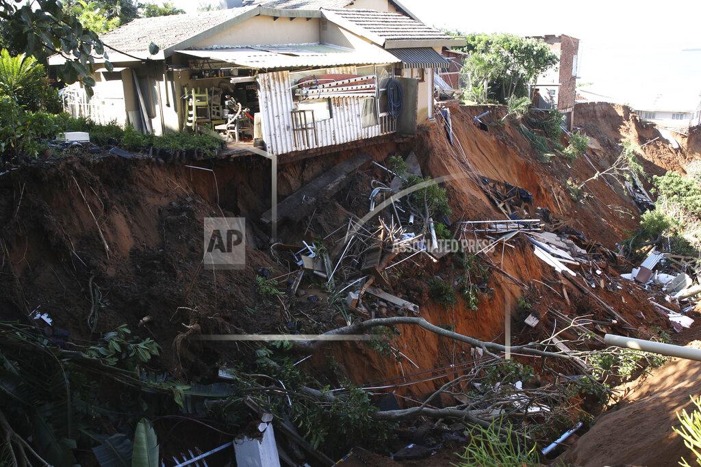 Uncredited Damaged homes on the edge of a precipice caused by flooding waters near Durban, South Africa, Monday, May 23, 2022. More than 300 people have been evacuated from their homes as a result of renewed heavy rains, flooding and mudslides in South Africa's KwaZulu-Natal province, weeks after severe flooding killed more than 400 people and displaced more than 40,000 others. (AP Photo)