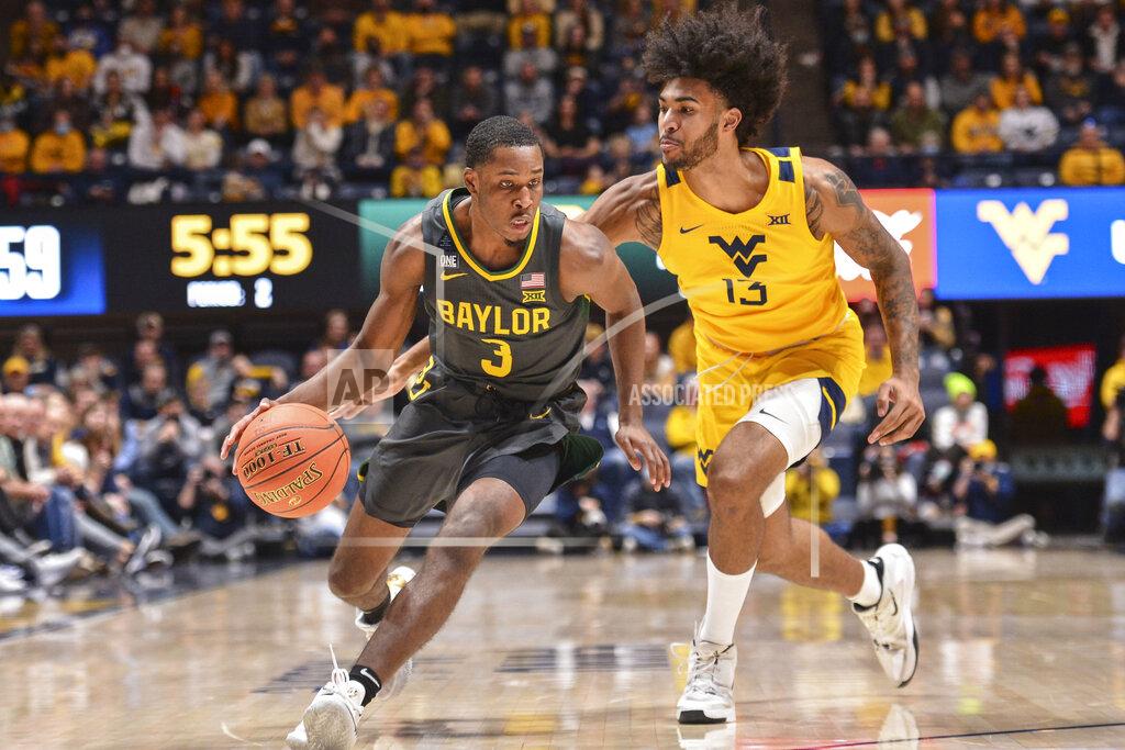 William Wotring Baylor guard Dale Bonner (3) protects the ball from West Virginia forward Isaiah Cottrell (13) during the second half of an NCAA college basketball game in Morgantown, W.Va., Tuesday, Jan. 18, 2022. (William Wotring)