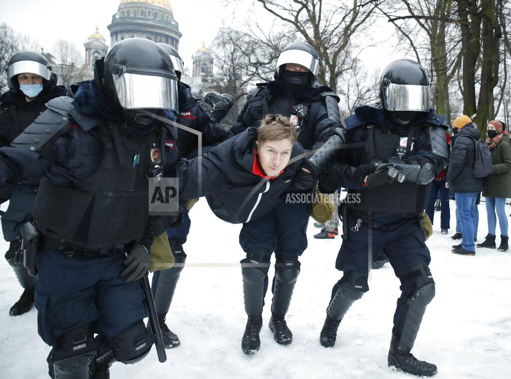 Dmitri Lovetsky Police detain a man during a protest against the jailing of opposition leader Alexei Navalny in People gather in St.Petersburg, Russia, Saturday, Jan. 23, 2021. Russian police are arresting protesters demanding the release of top Russian opposition leader Alexei Navalny at demonstrations in the country's east and larger unsanctioned rallies are expected later Saturday in Moscow and other major cities. (AP Photo/Dmitri Lovetsky)