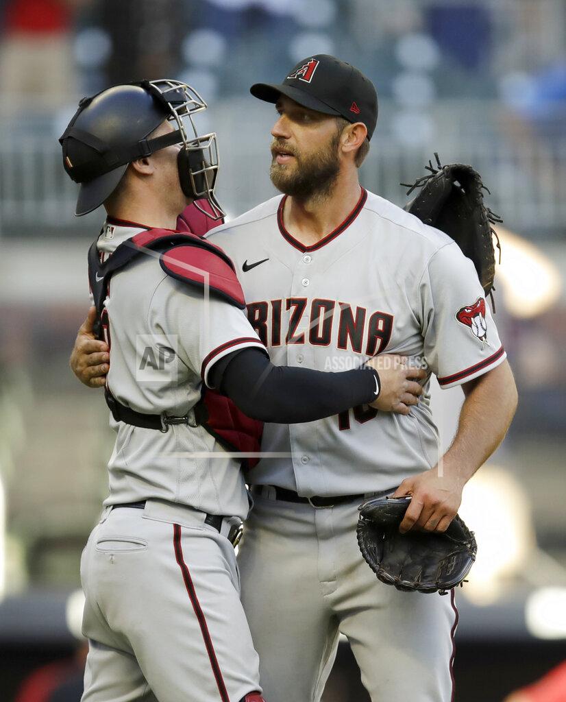 Ben Margot Arizona Diamondbacks pitcher Madison Bumgarner, right, is congratulated by catcher Carson Kelly after pitching a 7-inning no hitter against the Atlanta Braves, at the end of the second baseball game of a double header, Sunday, April 25, 2021, in Atlanta. (AP Photo/Ben Margot)