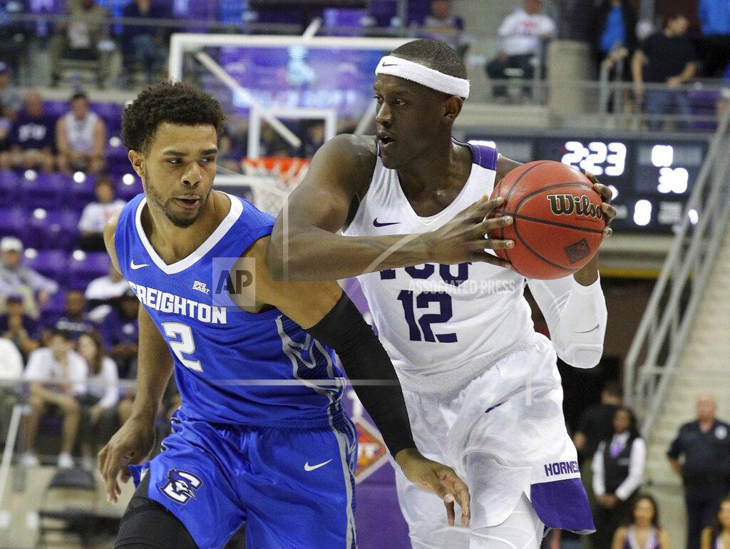Richard W. Rodriguez TCU forward Kouat Noi (12) drives against Creighton guard Connor Cashaw in an NCAA college basketball game in Fort Worth, Texas, Tuesday, March 26, 2019. (Richard W. Rodriguez/Star-Telegram via AP)