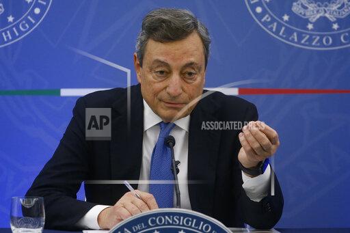 Italy's Prime Minister Mario Draghi holds a press conference after the Council of Ministers in Rome Wednesday, Nov. 24, 2021. The Italian government on Wednesday decided to exclude unvaccinated people from certain activities over the holidays in a bid to contain rising coronavirus infections and stave off financially crippling lockdowns just as the economy is starting to grow again. A new government decree also makes vaccinations, including booster shots, mandatory for law enforcement, military and all school employees. Previously, vaccines were only required for health care workers and teachers. (Fabio Frustaci/LaPresse pool via AP)